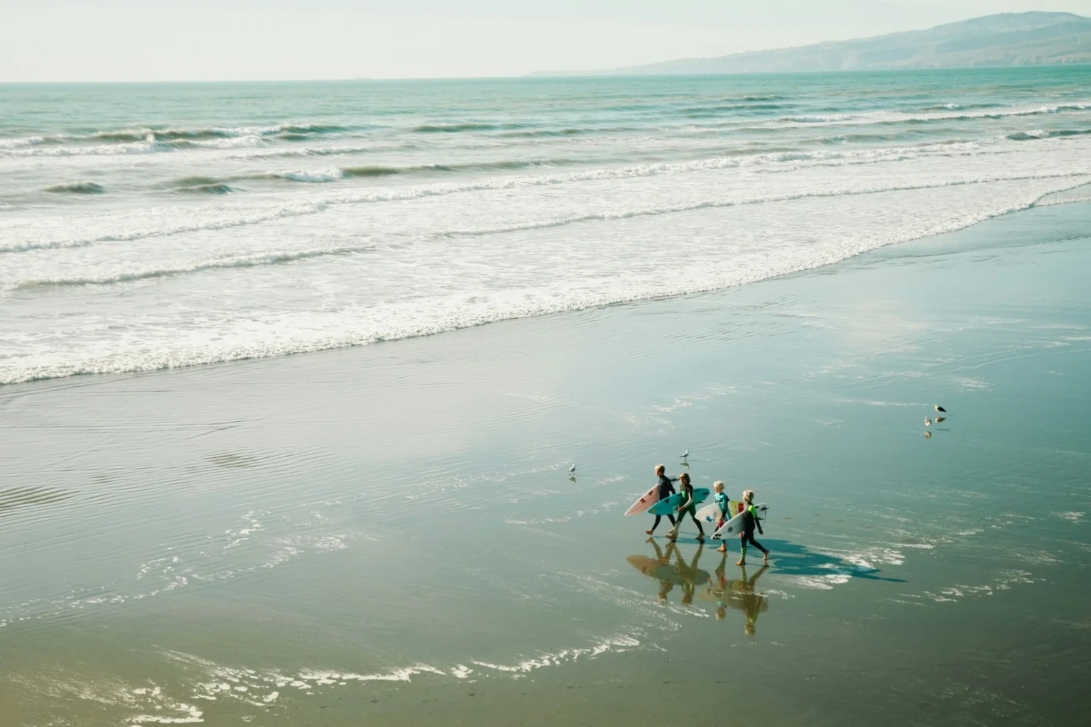 Atlantic Surf Point guests walking to the shoreline with surfboards